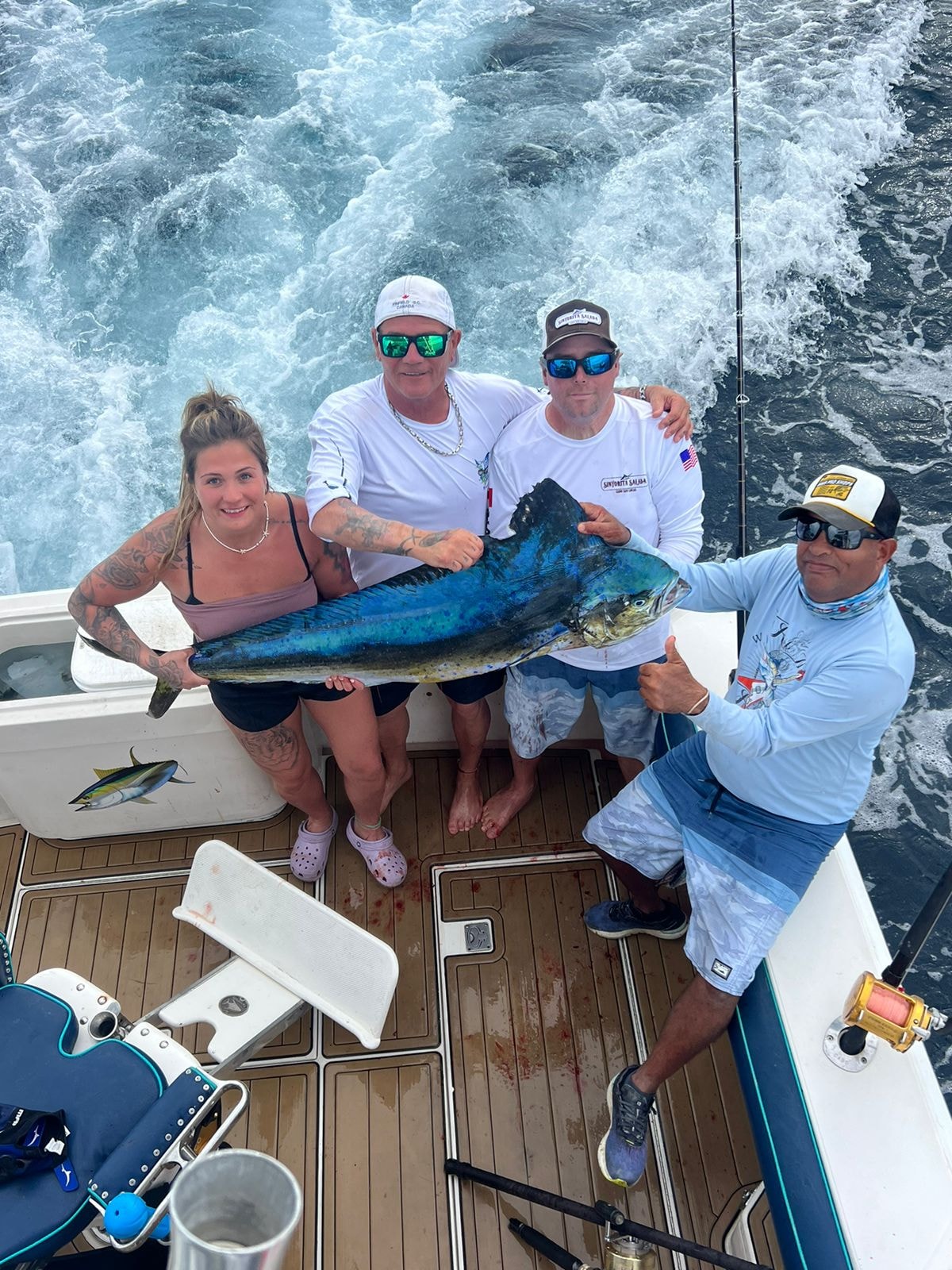 Group of four with mahi-mahi on deck